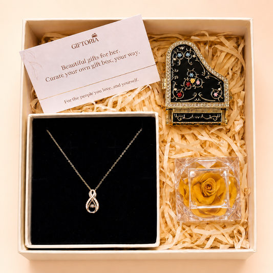 Golden Infinity Necklace gift set with a preserved yellow rose and vintage piano jewellery box.