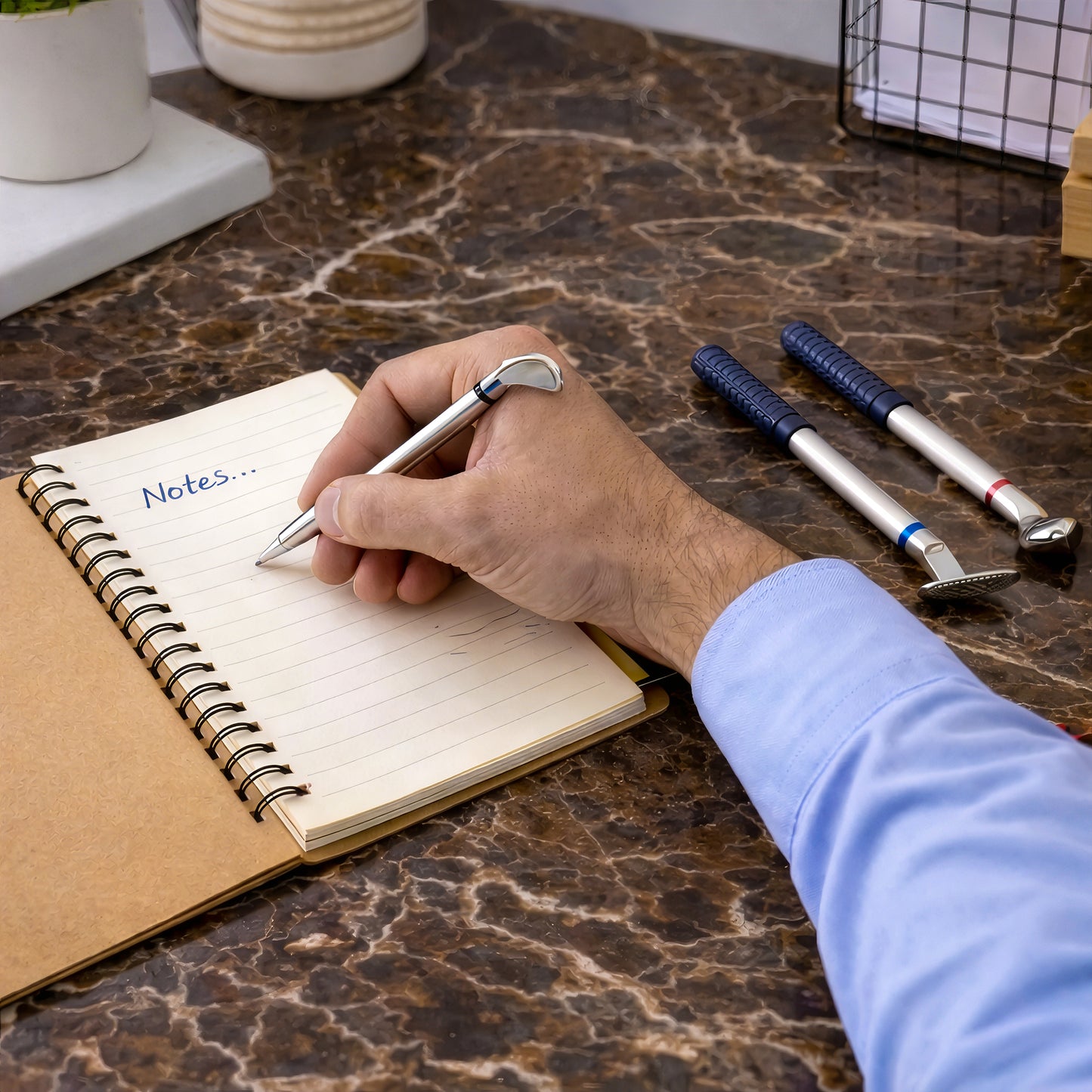 Close up of golf pen set writing on notebook