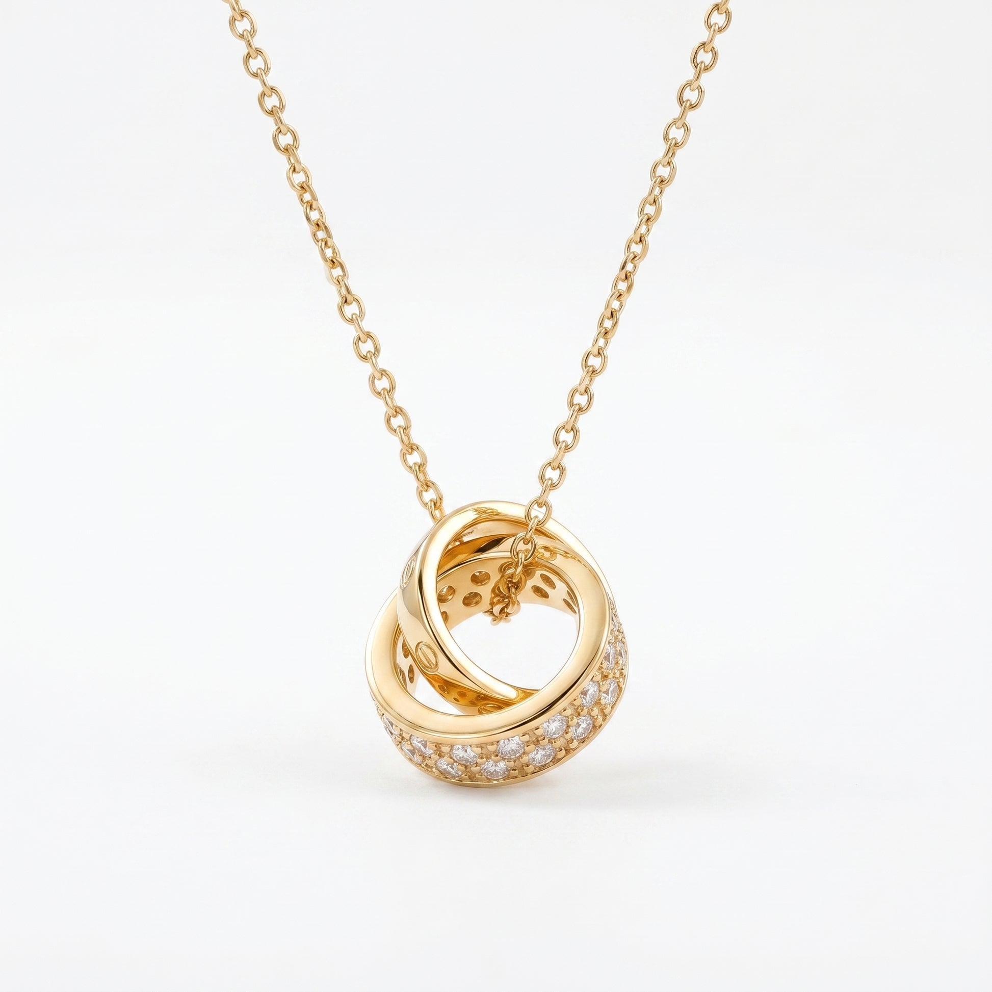 Gold Interlocking Circle Pendant Necklace with sparkling crystal detail on white background