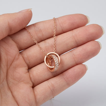 Rpse Gold Interlocking Circle Pendant Necklace held in hand showing pendant size
