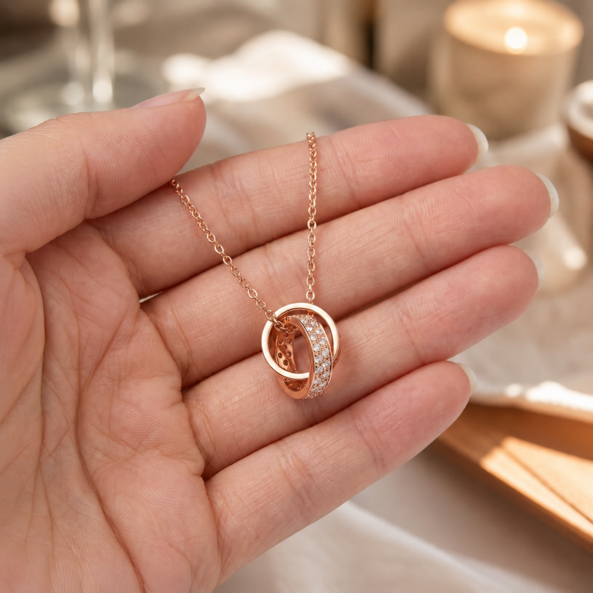 Rpse Gold Interlocking Circle Pendant Necklace held in hand showing pendant size