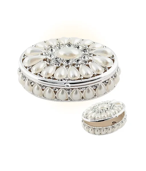 Round decorative item with pearl-like stones and silver accents on a white background