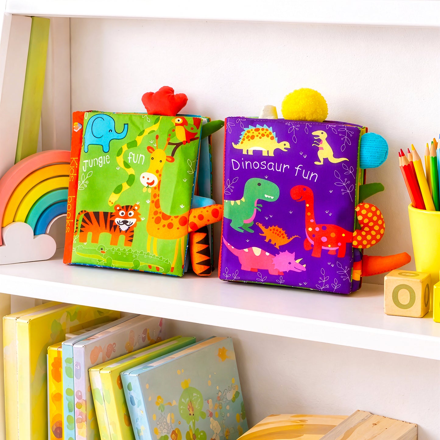 Jungle and Dinosaur baby soft book set displayed on nursery shelf