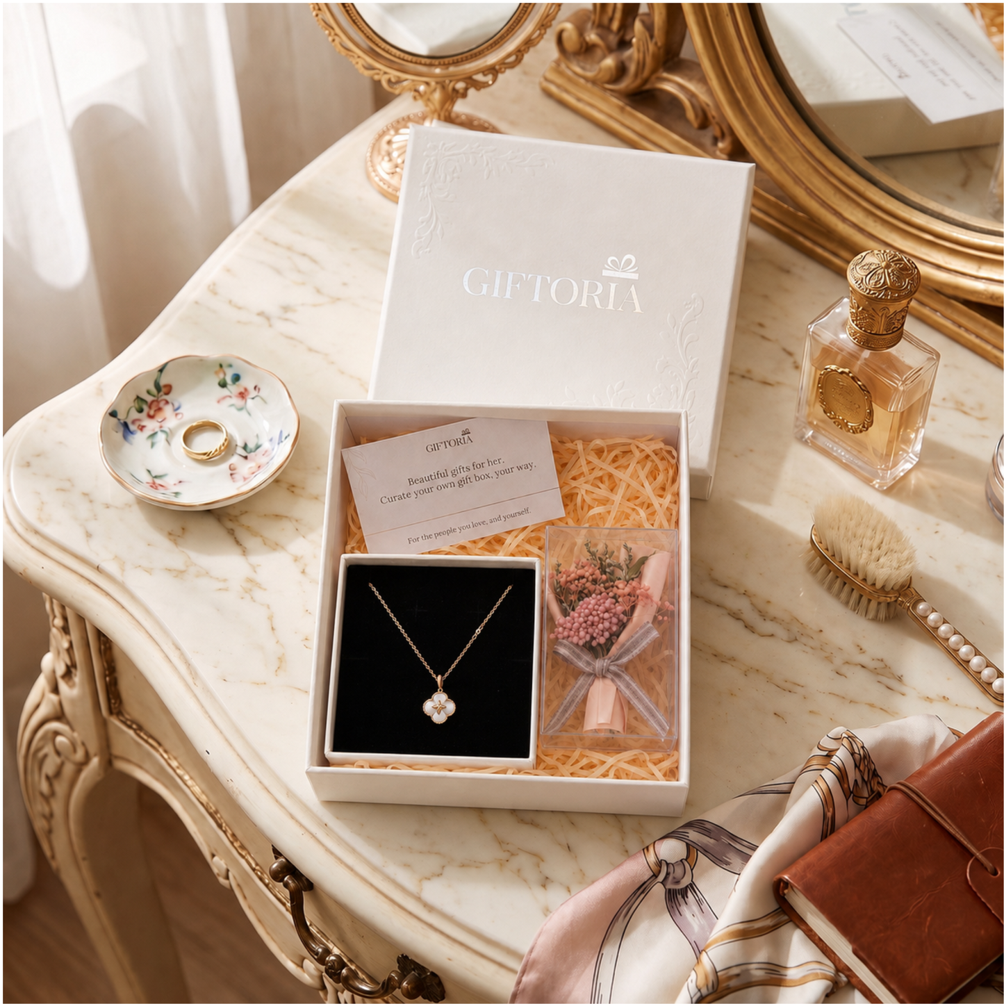 Lucky clover necklace and pink dried flower gift set styled on an elegant dressing table