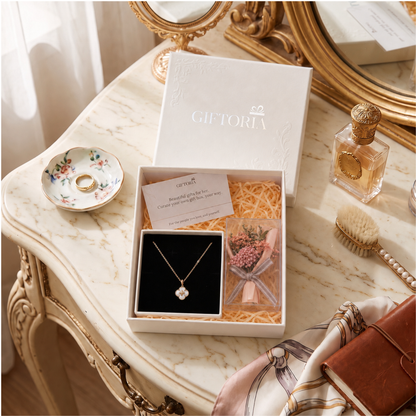 Lucky clover necklace and pink dried flower gift set styled on an elegant dressing table