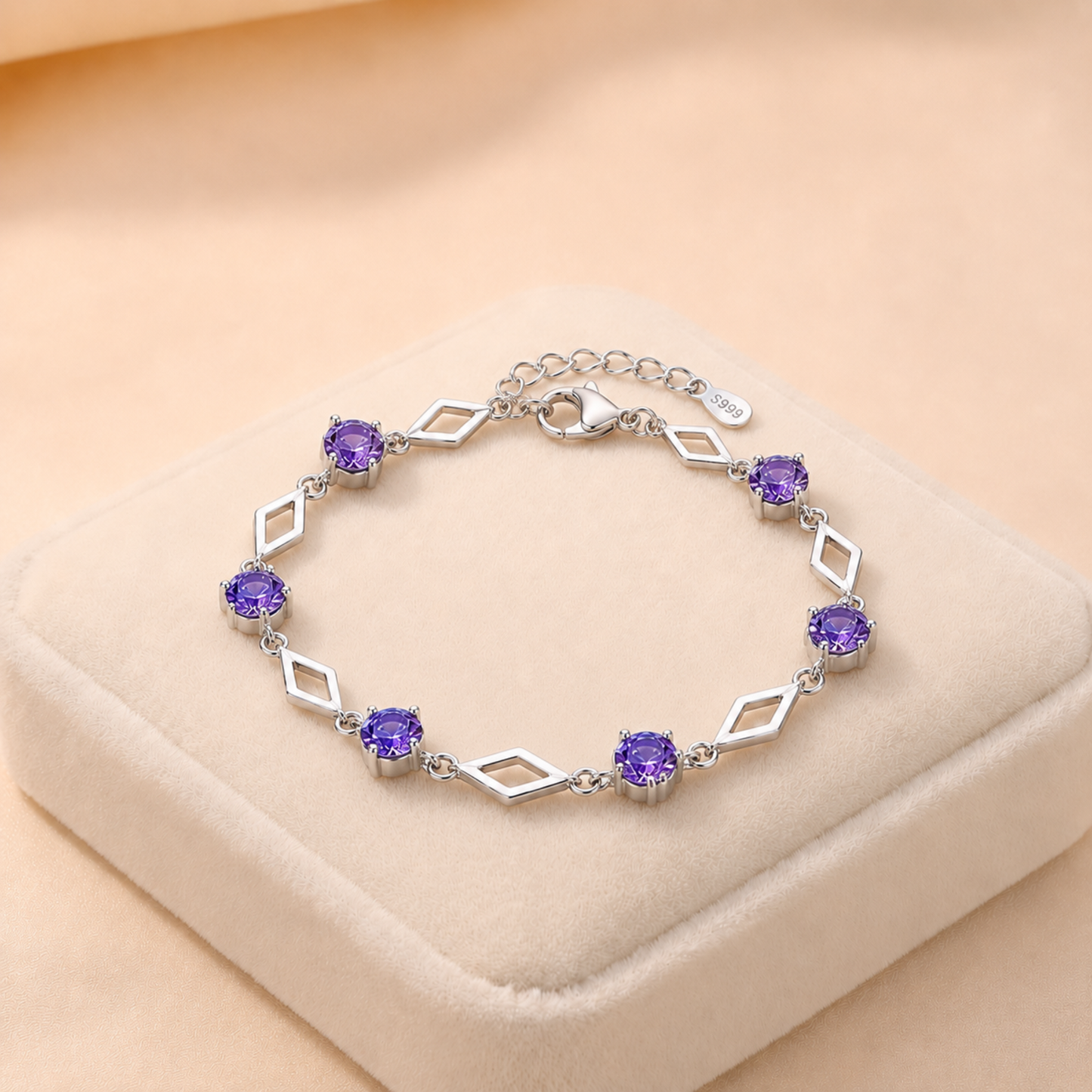 Luminous Love purple cubic zirconia 999 fine silver bracelet on a cream jewellery cushion
