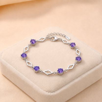 Luminous Love purple cubic zirconia 999 fine silver bracelet on a cream jewellery cushion