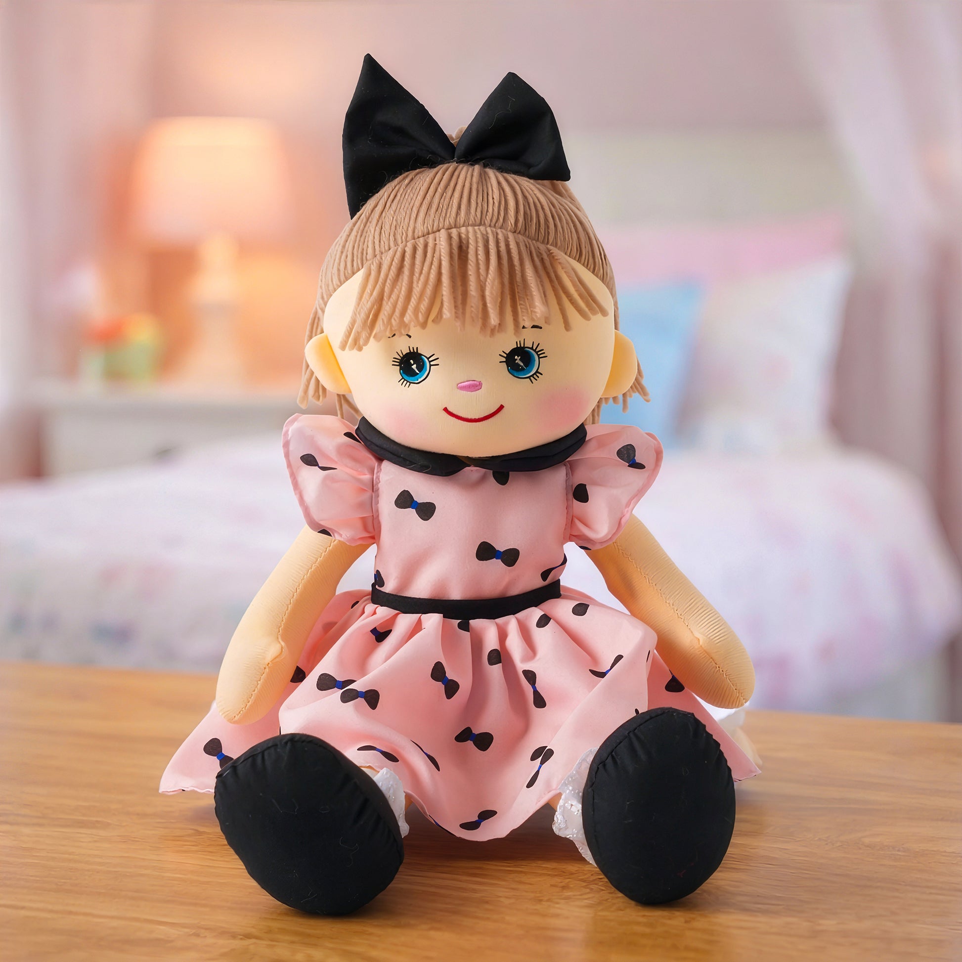 Mia plush doll toy in pink dress with bow detail
