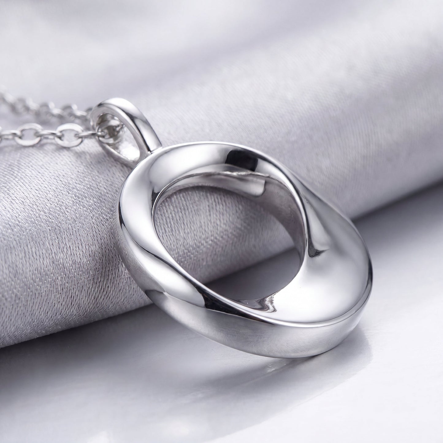 Close-up of the polished open circle pendant on a 925 sterling silver necklace