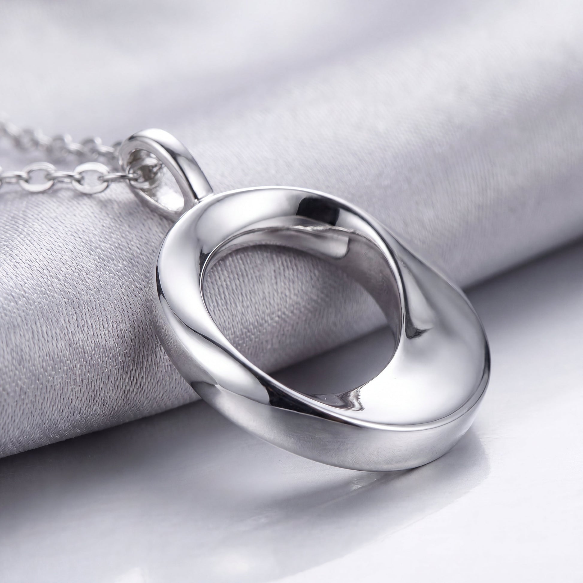 Close-up of the polished open circle pendant on a 925 sterling silver necklace