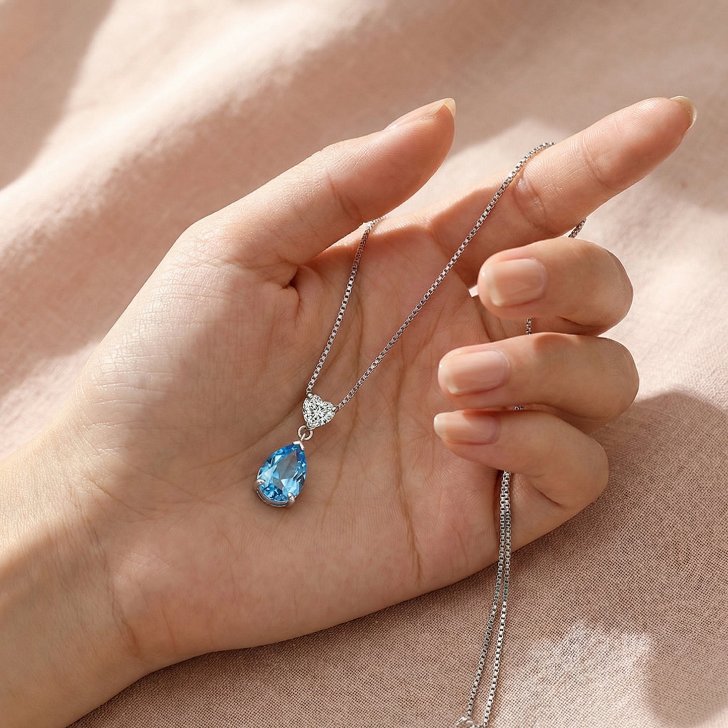Close up of ocean heart blue necklace held in hand, 925 sterling silver romantic pendant gift for girlfriend or wife