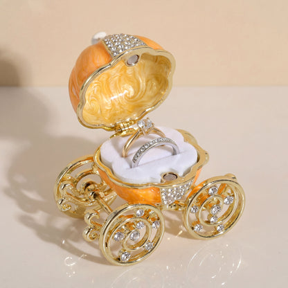 Vintage orange pumpkin carriage jewellery box displaying a ring inside, a charming gift-ready jewellery storage box.