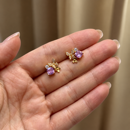 Pink Gold Butterfly Garden stud earrings held in hand to show their size