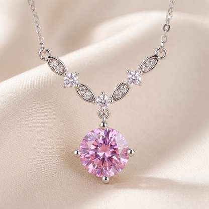 Close up of pink cubic zirconia floral vine necklace with sparkling leaf details