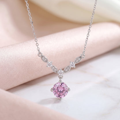 Pink cubic zirconia floral vine necklace on soft pink satin background