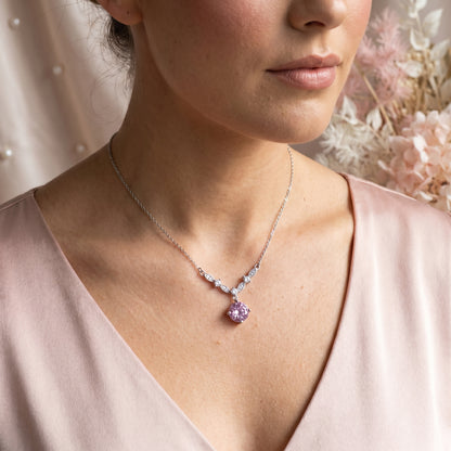 Pink cubic zirconia floral vine necklace styled on model with soft pink outfit