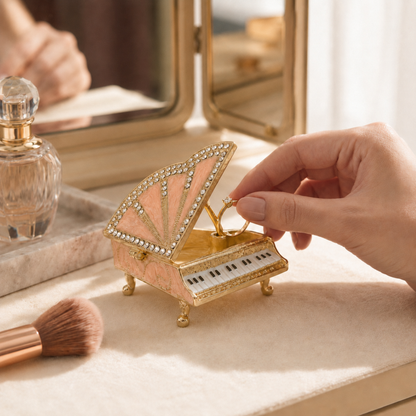 Woman opening the lid of a pink grand piano jewellery box