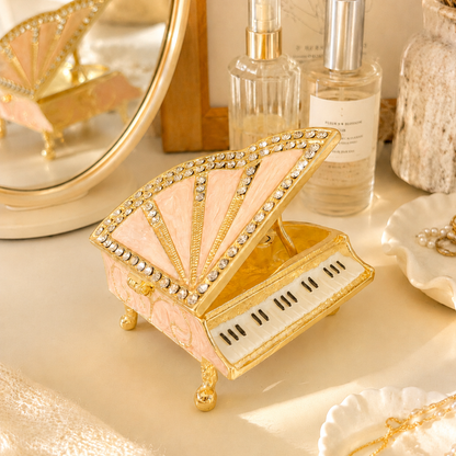 Pink crystal piano jewellery box displayed on an elegant dressing table