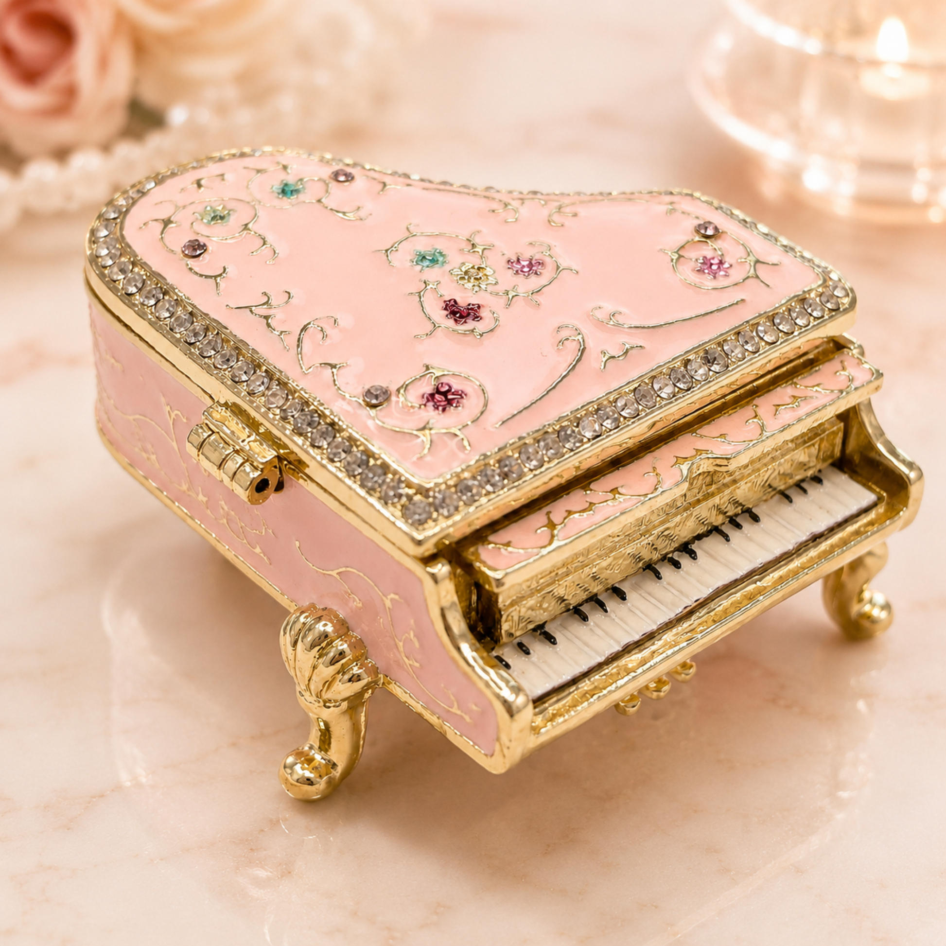 Pink vintage floral grand piano jewellery box, set on a light marble surface with soft decorative background elements.