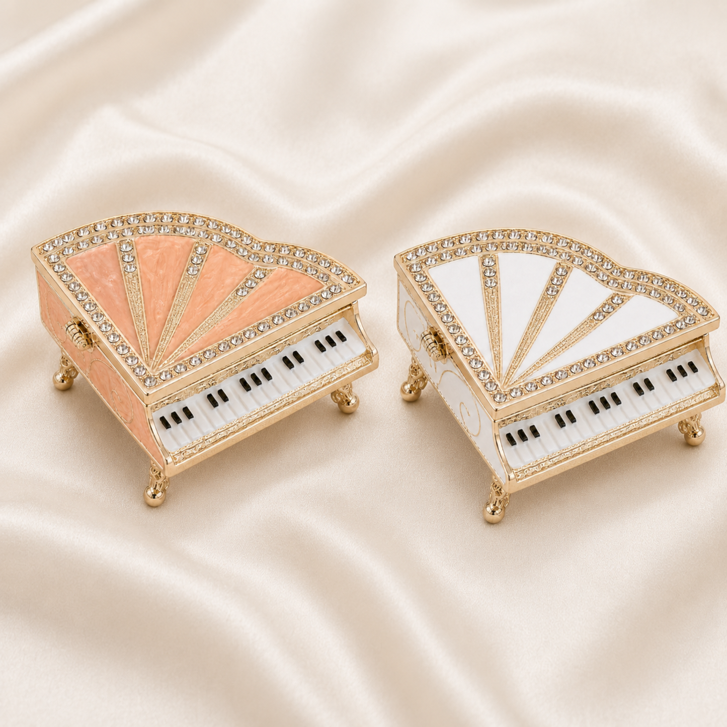 Pink and white crystal grand piano jewellery boxes displayed on satin