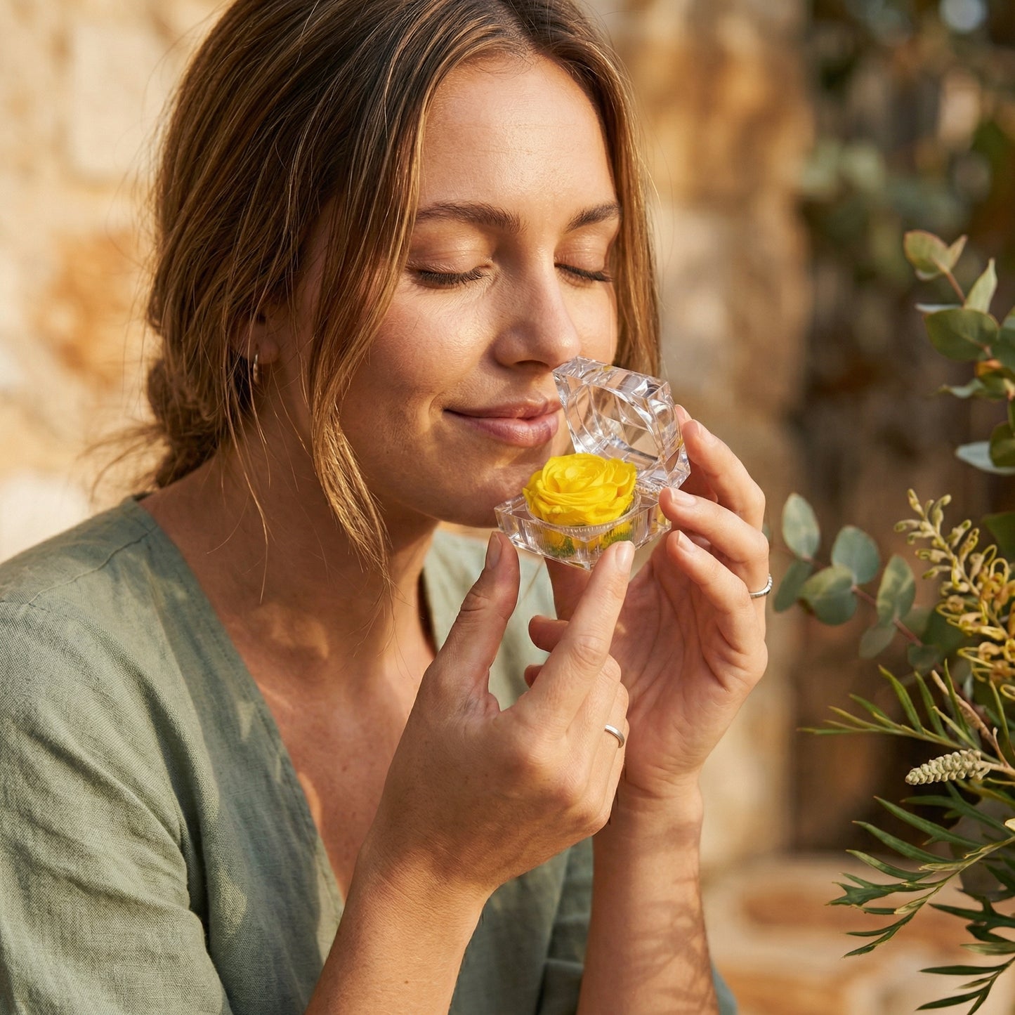 Woman holding yellow Preserved Rose Crystal Gift Box in a warm lifestyle scene
