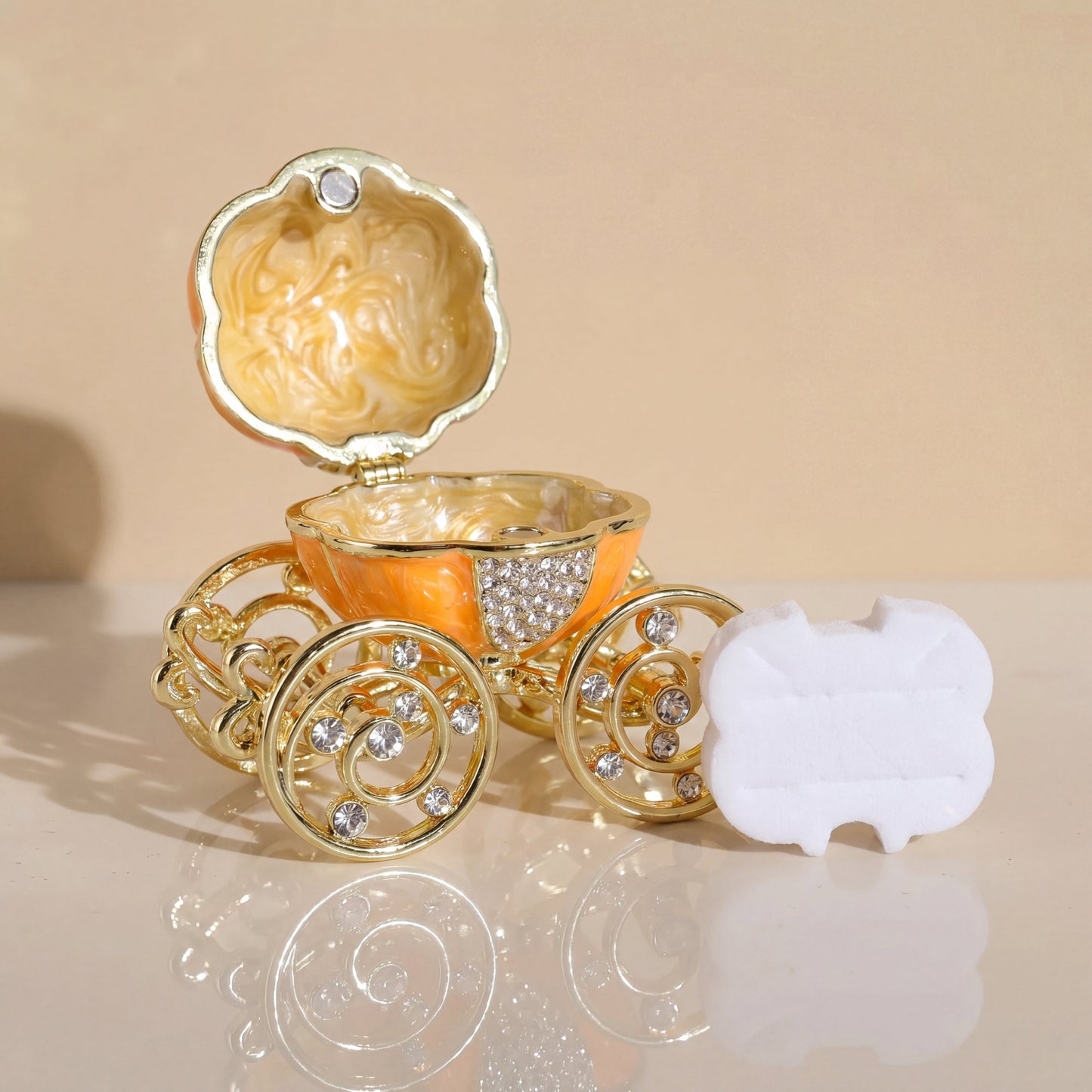 Orange pumpkin carriage jewellery b oxwith removable white ring holder, designed for storing rings and small jewellery pieces.