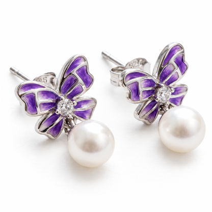 Front view of purple butterfly sterling silver earrings with pearl drops
