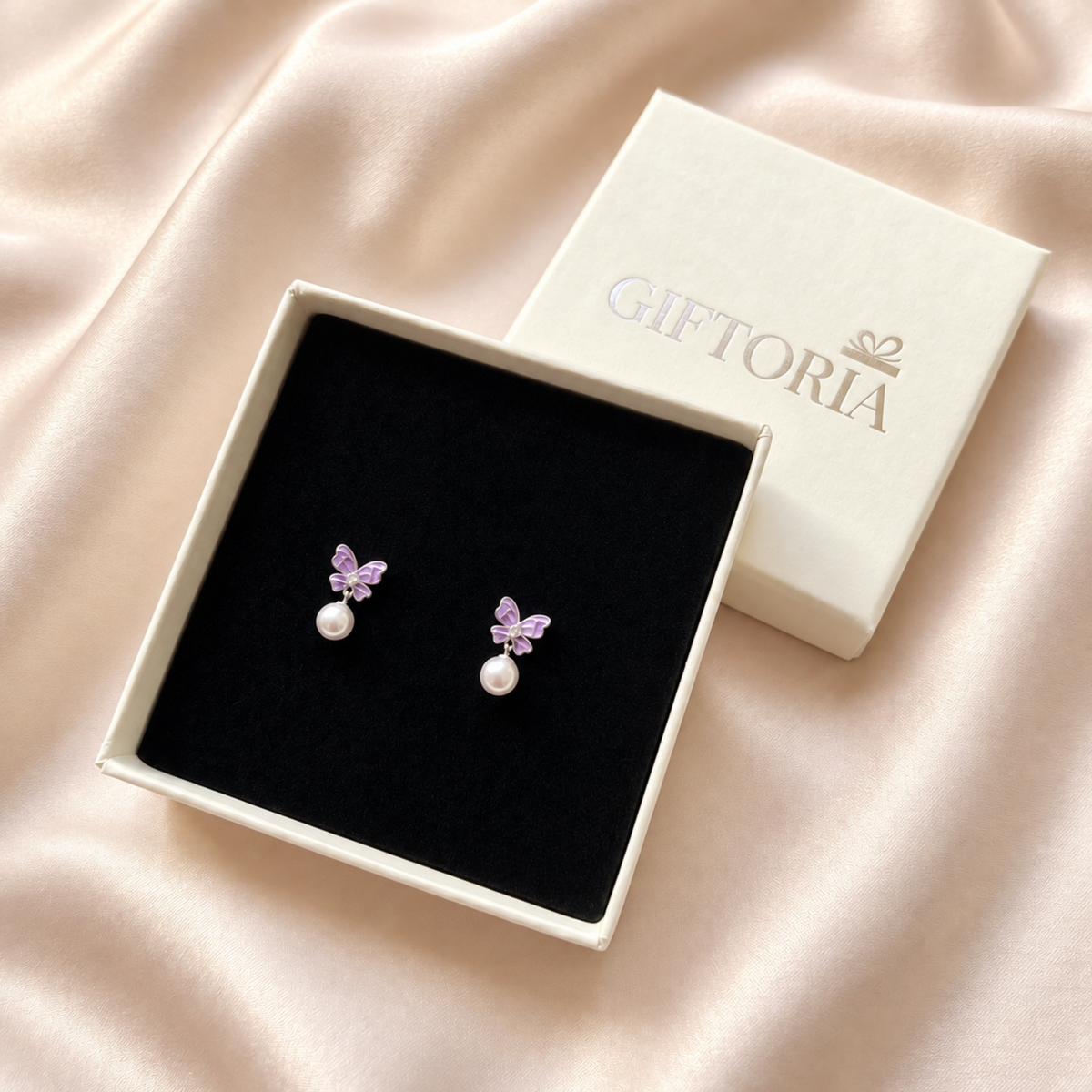 Purple butterfly pearl drop earrings presented in a Giftoria jewellery gift box