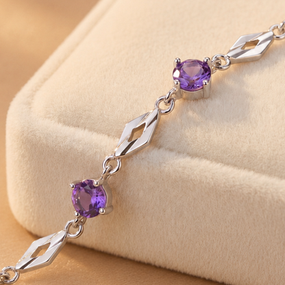 Close-up detail of purple cubic zirconia stones and polished 999 fine silver bracelet links