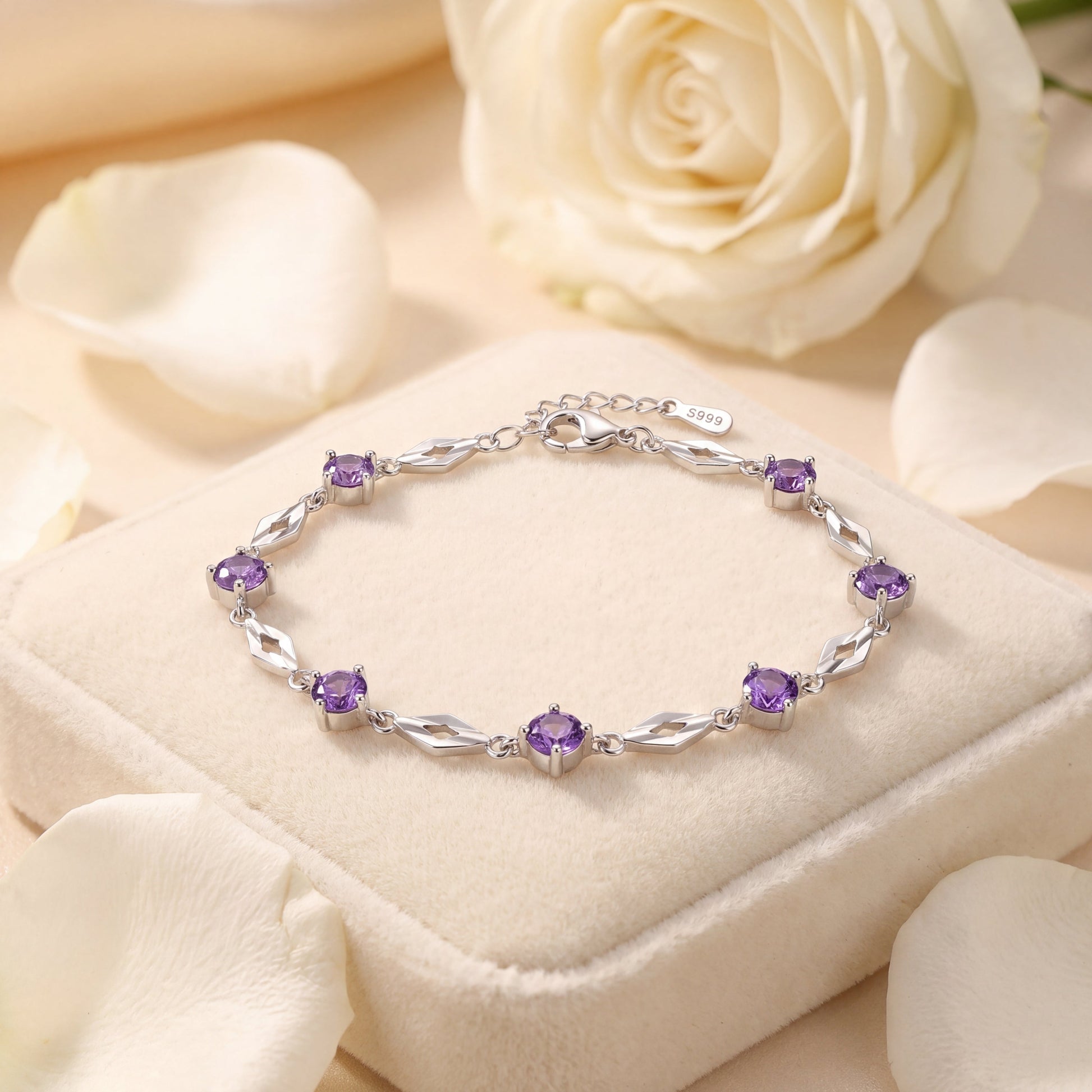 Purple CZ silver bracelet displayed on cream jewellery cushion with soft floral styling