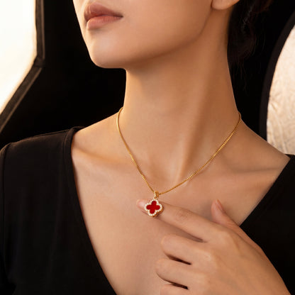 red four leaf clover pendant necklace with gold chain worn by model