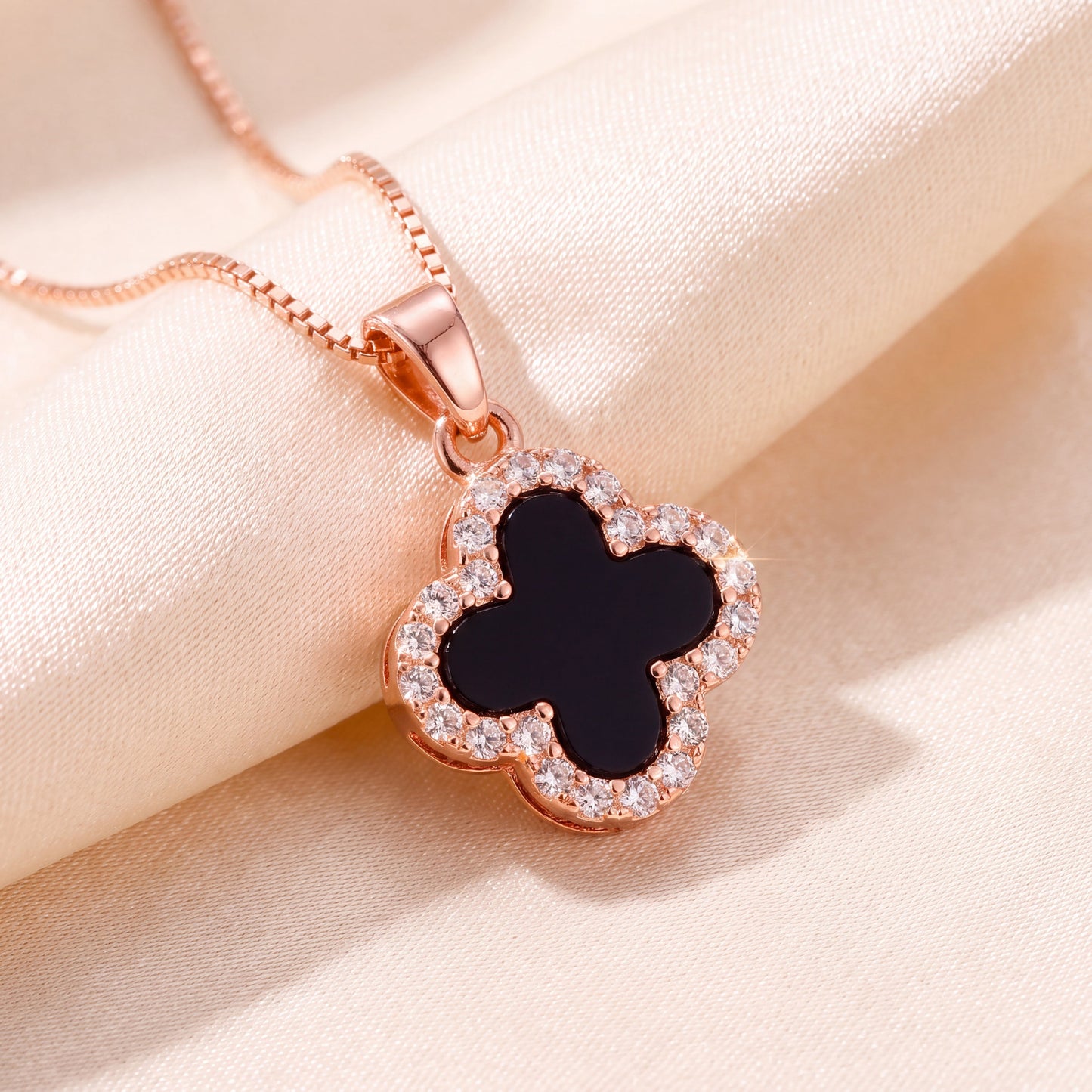rose gold black four leaf clover pendant necklace close up