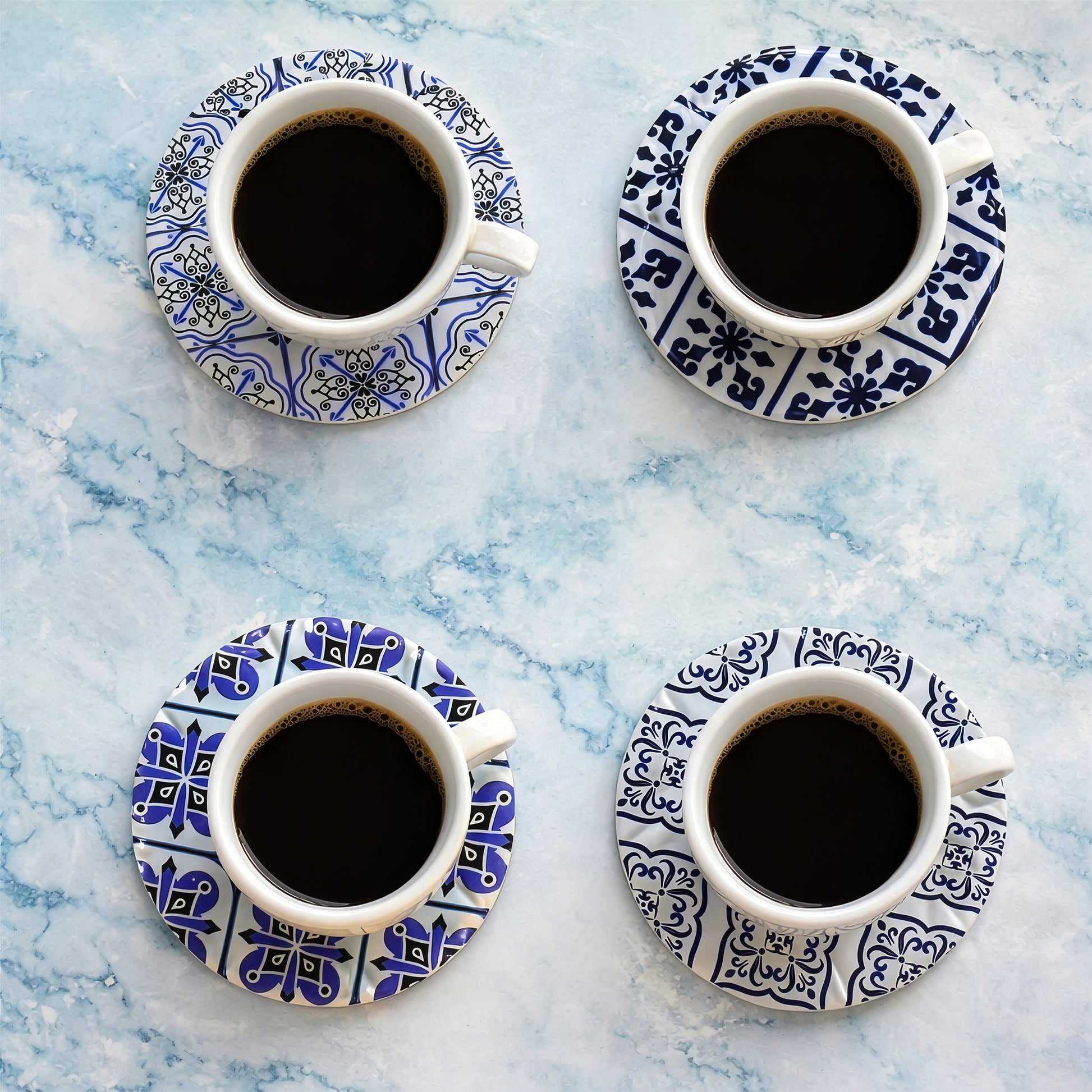 Round ceramic coaster set 4pcs under coffee cups on marble surface
