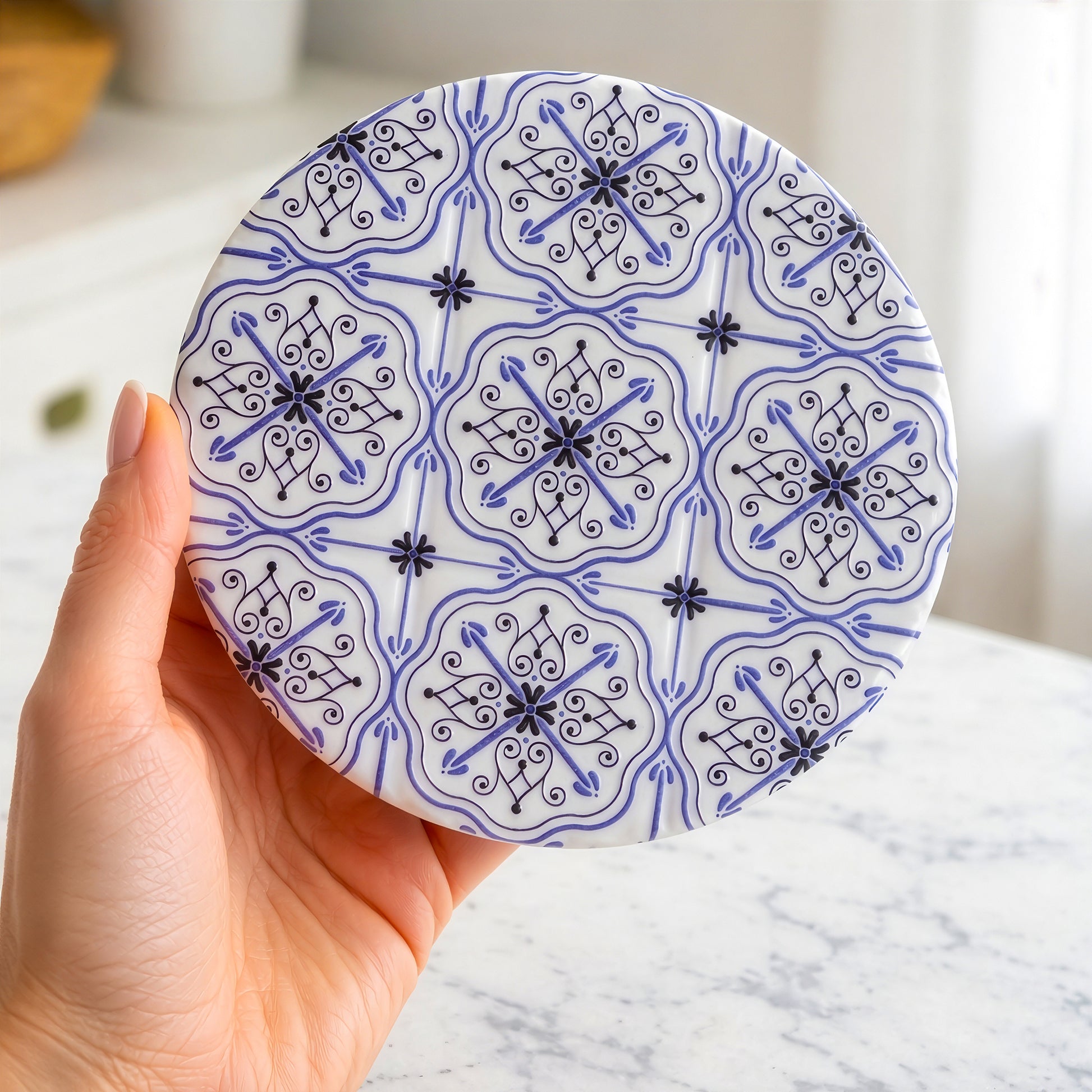 Round ceramic drink coaster blue pattern close up detail