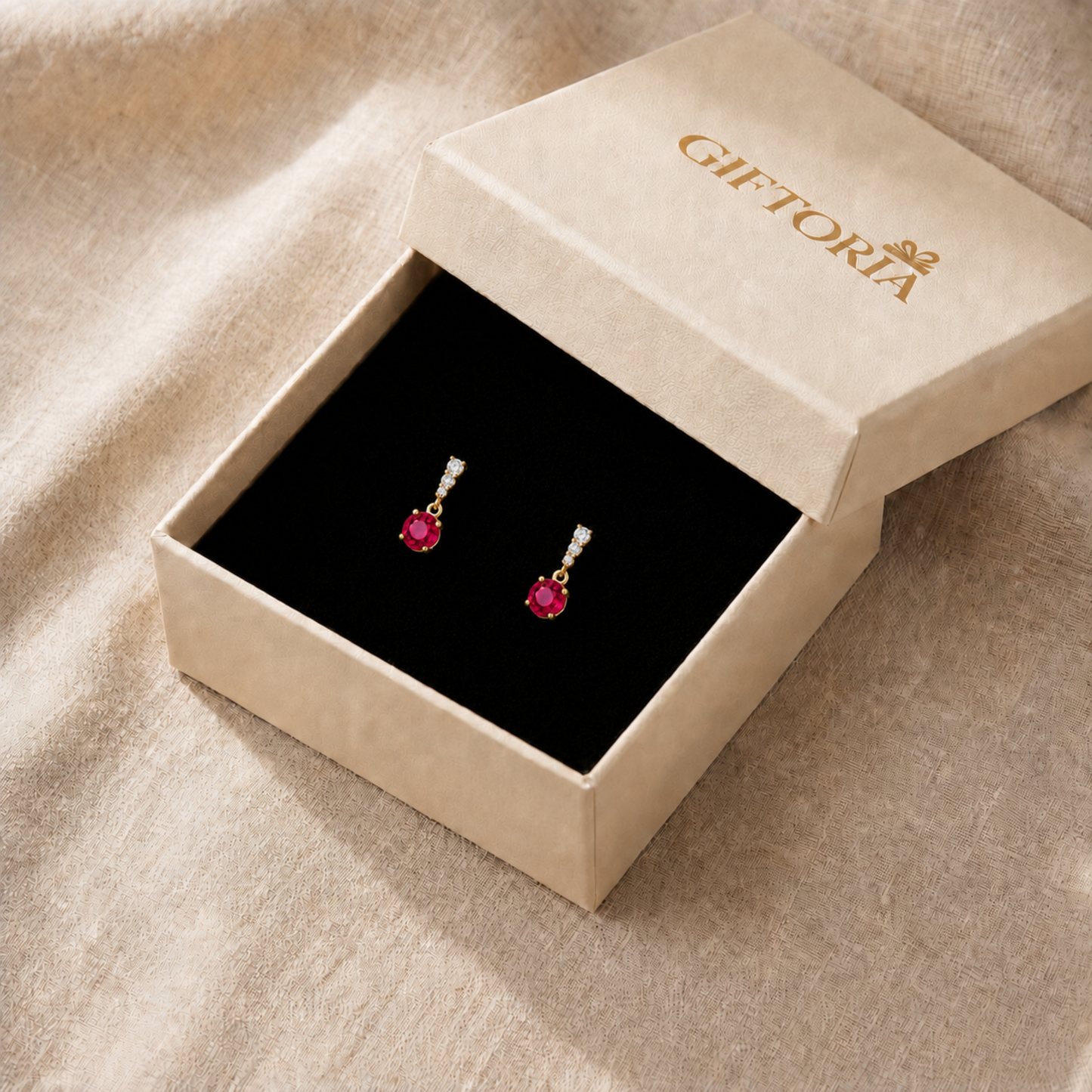 Ruby red drop earrings presented in a Giftoria jewellery gift box