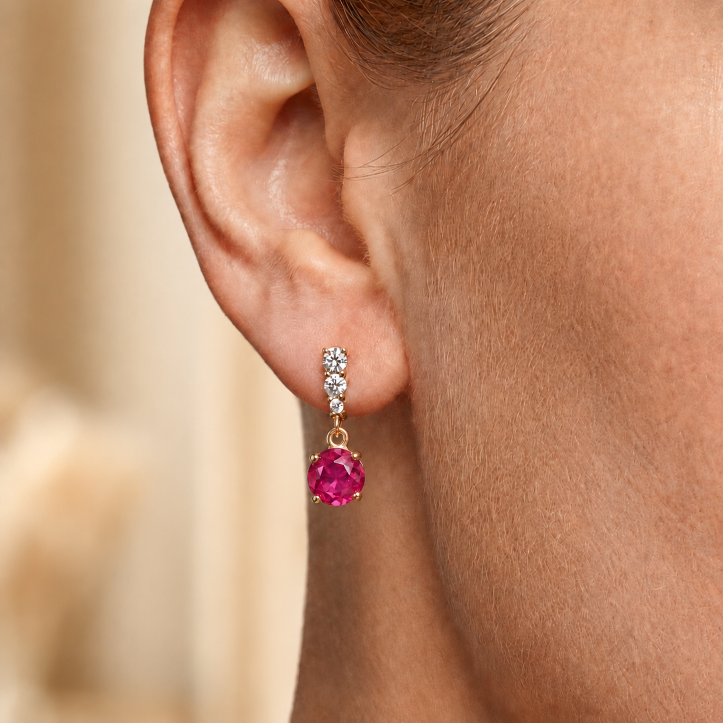 Ruby red sterling silver drop earrings worn on the ear