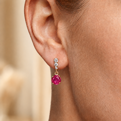Ruby red sterling silver drop earrings worn on the ear