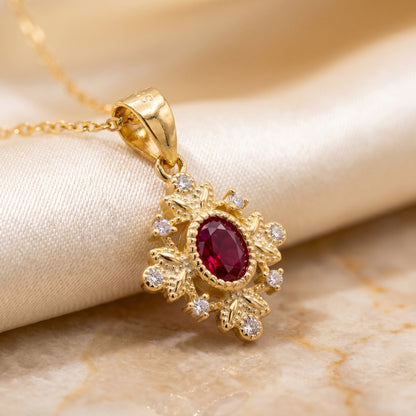 Close-up of a gold 925 sterling silver ruby red vintage pendant with sparkling crystal details