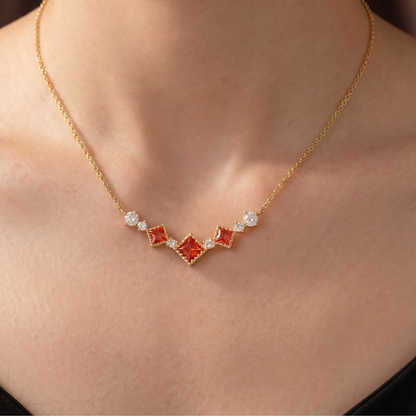 Gold Scarlet Vintage red cubic zirconia necklace worn on a woman's neckline
