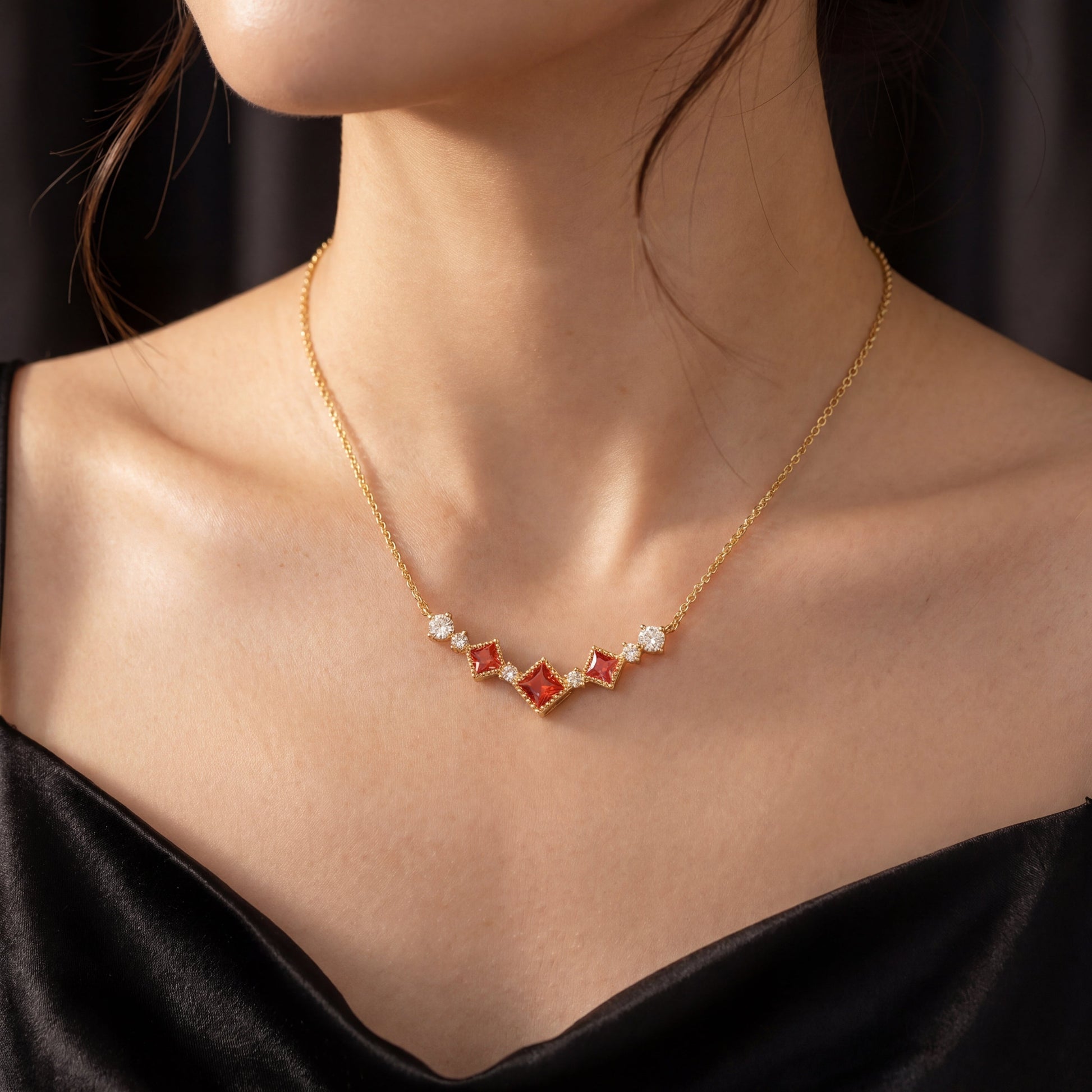 Model wearing scarlet vintage red cubic zirconia necklace in a black dress