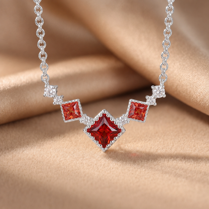 Silver Scarlet Vintage 925 sterling silver necklace with red cubic zirconia on champagne satin