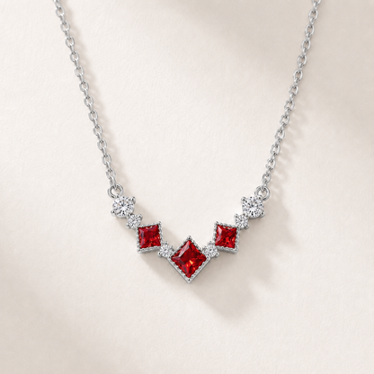 Front view of the silver Scarlet Vintage red cubic zirconia necklace on a white background