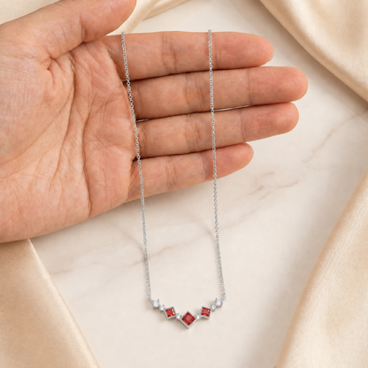 Silver Scarlet Vintage red cubic zirconia necklace held by hand to show its size