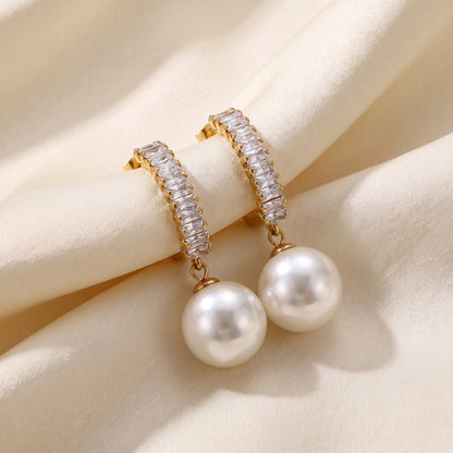 Statement Sparkling Baguette Pearl Drop Earrings styled on champagne satin