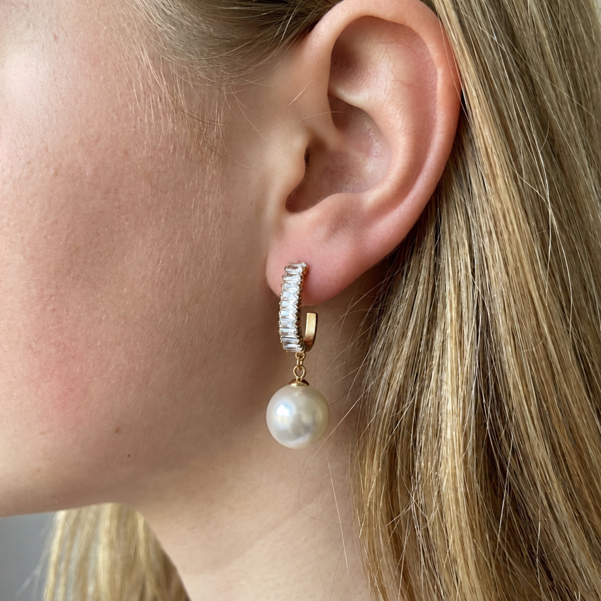 Woman wearing Statement Sparkling Baguette Pearl Drop Earrings for an elegant look