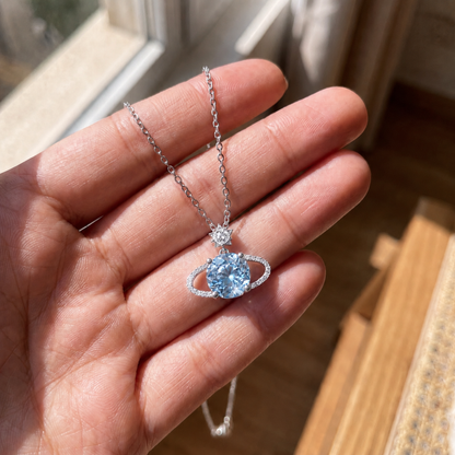 925 sterling silver Blue Planet star necklace held in hand showing pendant size