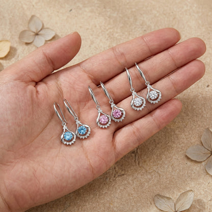 Three colour teardrop dancing cubic zirconia earrings shown in hand for size reference