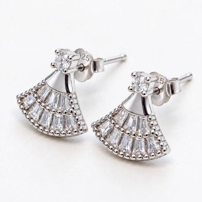 Angled view of the silver fan-shaped earrings, showing the studs and stone-set design.