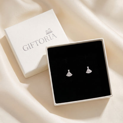 Silver fan-shaped earrings displayed in a black jewellery box beside Giftoria packaging.