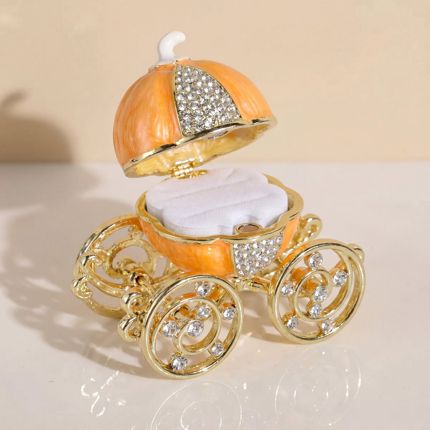 Orange pumpkin carriage jewellery box with removable white ring holder, designed for storing rings and small jewellery pieces.